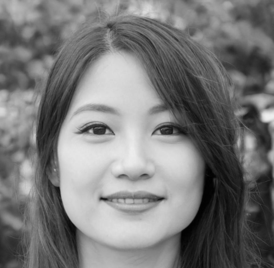 Design instructor Elena reviewing student work and providing feedback